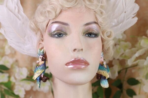 A mannequin with long blonde hair and blue earrings.