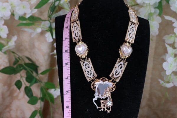 A necklace with a horse on it and a pink measuring tape.