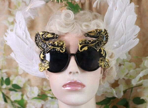 A mannequin wearing sunglasses with gold leaves on them.