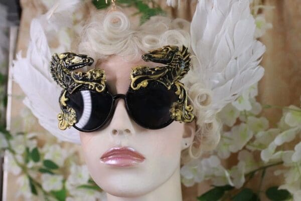 A woman with blonde hair and black sunglasses.