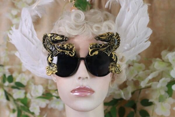 A woman with blonde hair wearing black and gold sunglasses.