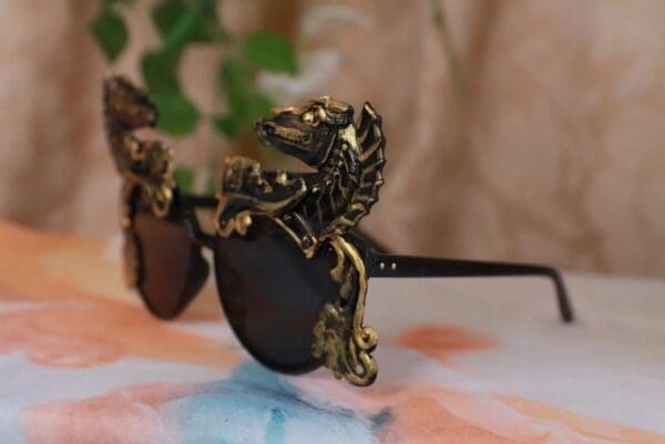 A pair of sunglasses with a bird on the side.