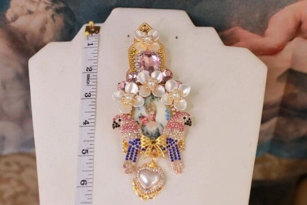 A white table with a ruler and some jewelry
