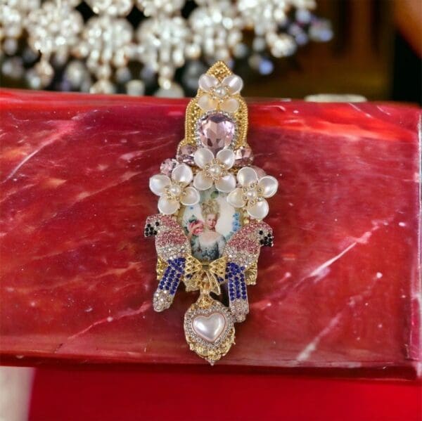 A close up of a red purse with some jewelry on it