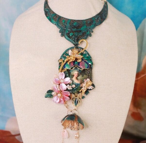 A necklace with a green and blue floral design.
