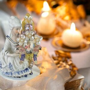 A statue of an angel with candles in the background.