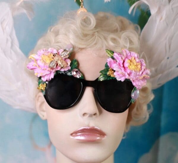 A mannequin wearing sunglasses with flowers on them.