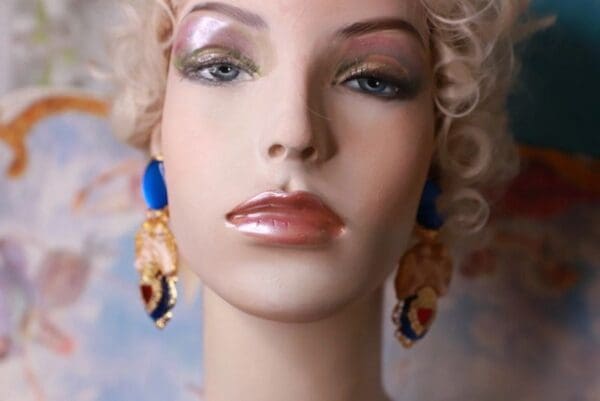 A mannequin with blonde hair and blue earrings.