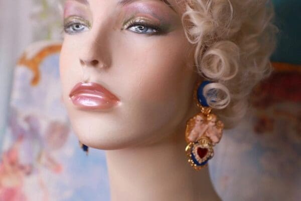 A mannequin with pink lipstick and long earrings.