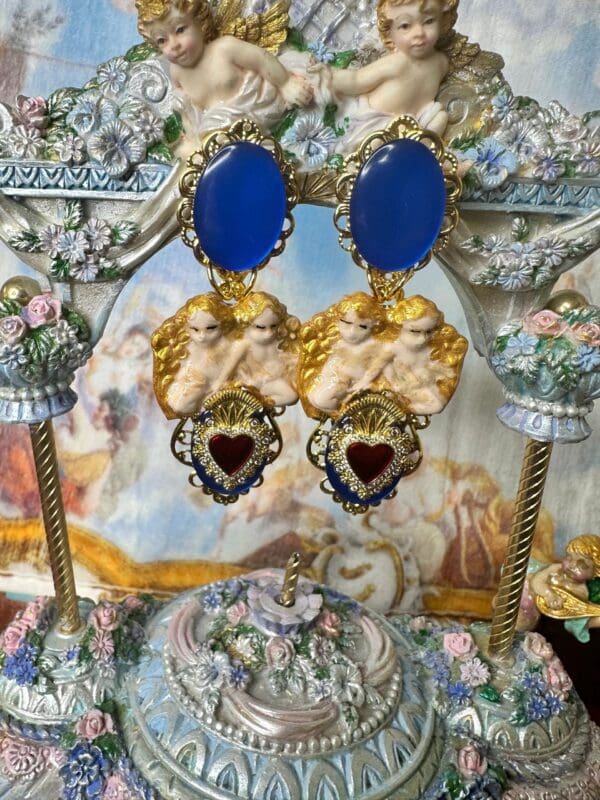 A pair of earrings with blue and red hearts.