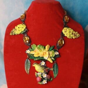 A red display stand with a necklace on it