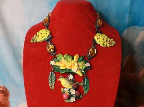 A red display stand with a necklace on it