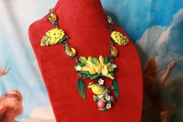 A red display stand with a necklace on it
