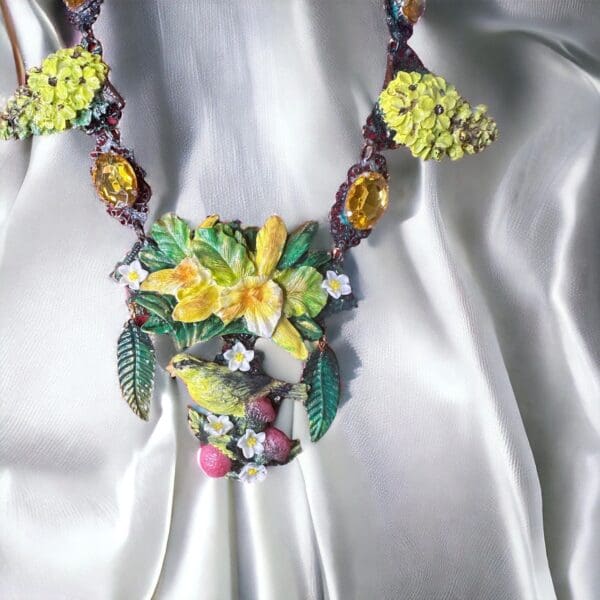 A necklace with flowers and leaves on it.