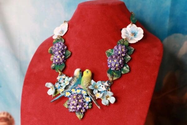 A necklace with grapes and flowers on it