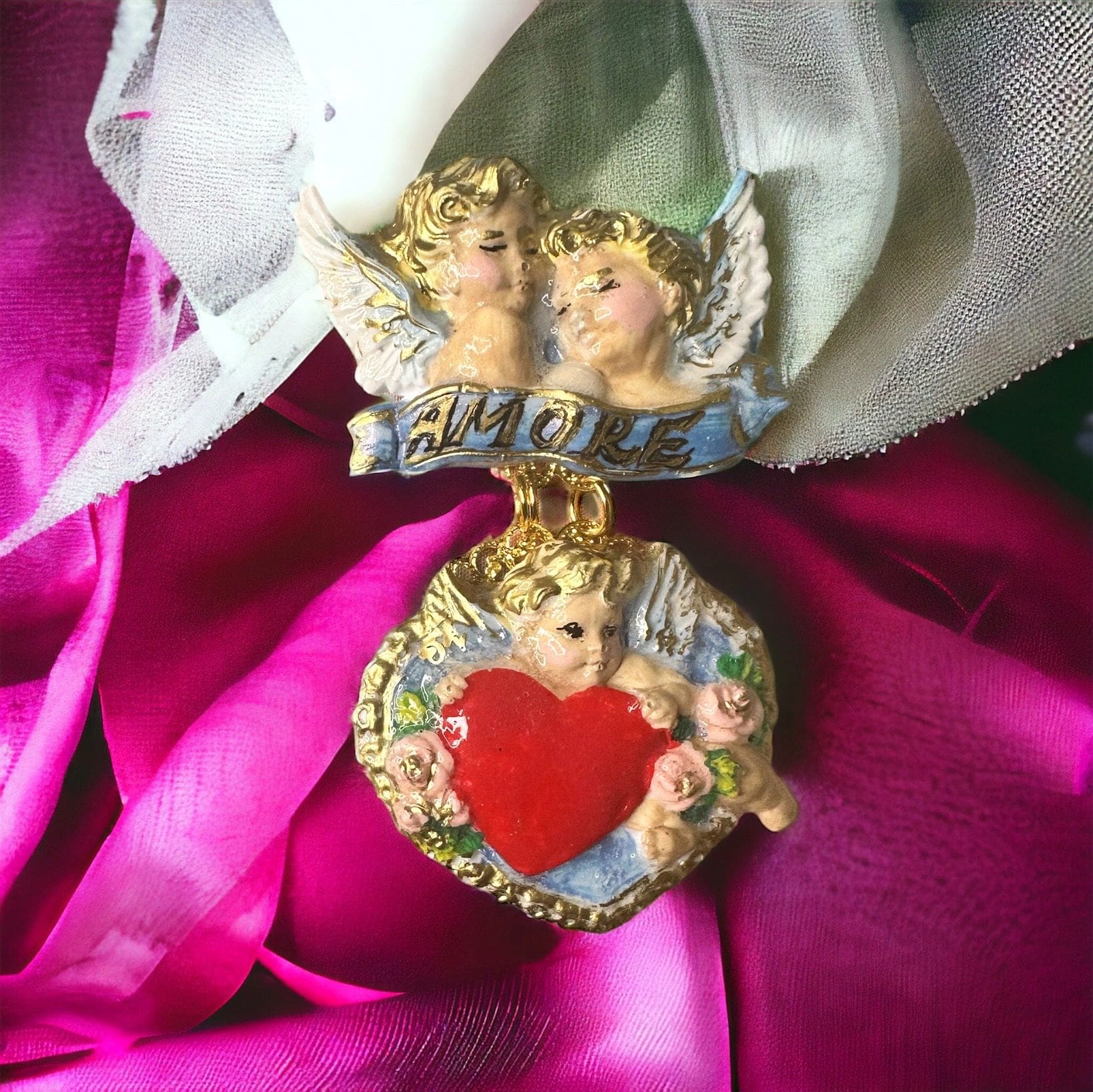 A close up of two angels on top of a pink cloth