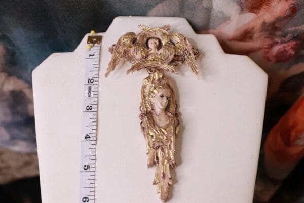 A gold statue of an angel with wings and halo.
