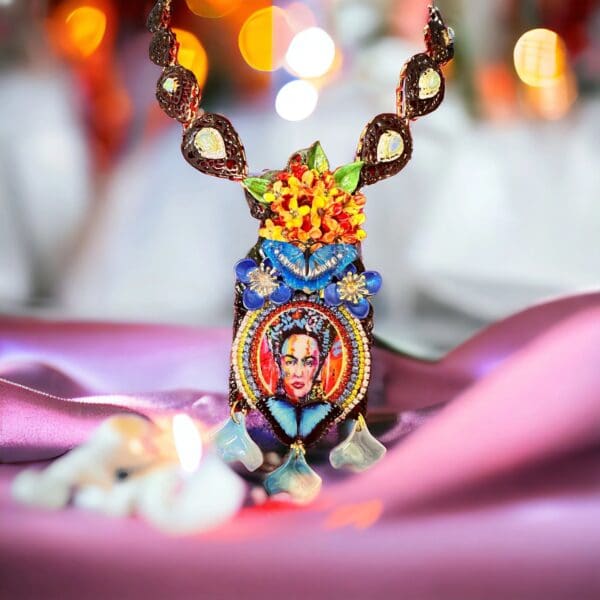 A necklace with a picture of frida kahlo on it.