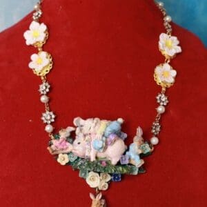 A necklace with flowers and a bunny rabbit.