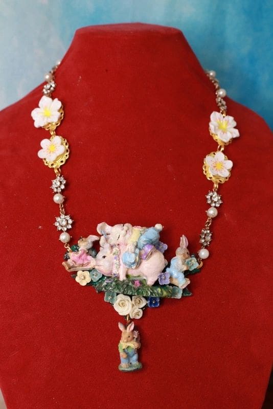 A necklace with flowers and a bunny rabbit.
