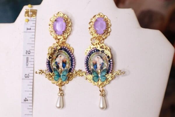 A pair of earrings with a picture on them