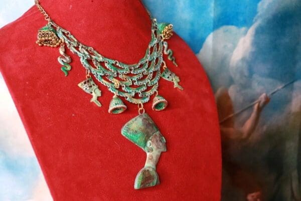 A red necklace with green and white beads