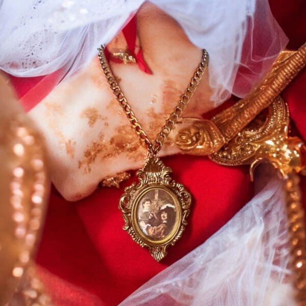 A gold necklace with a picture of jesus on it.