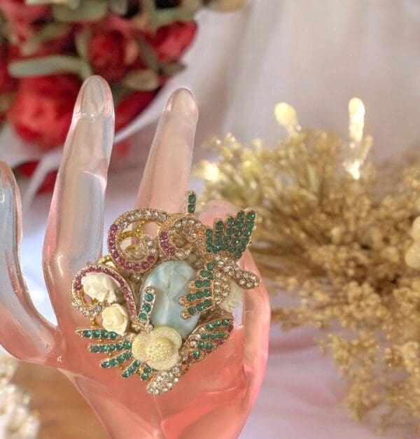 A hand holding something with flowers on it