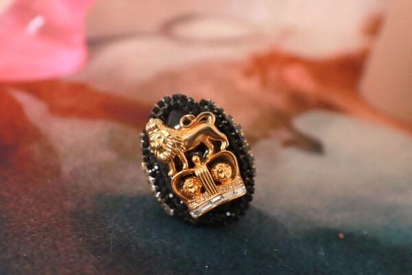 A black and gold ring with a horse on it