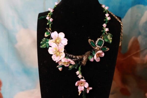 A necklace with flowers and leaves on it