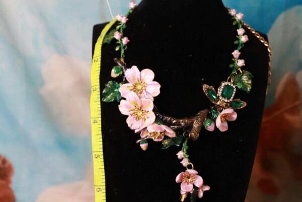 A necklace with flowers and leaves on it