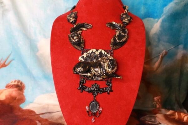 A red necklace with some black and white jewelry on it