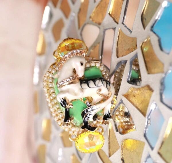 A close up of a gold and green elephant