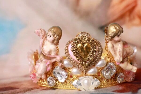 A close up of a crown with some figurines on it