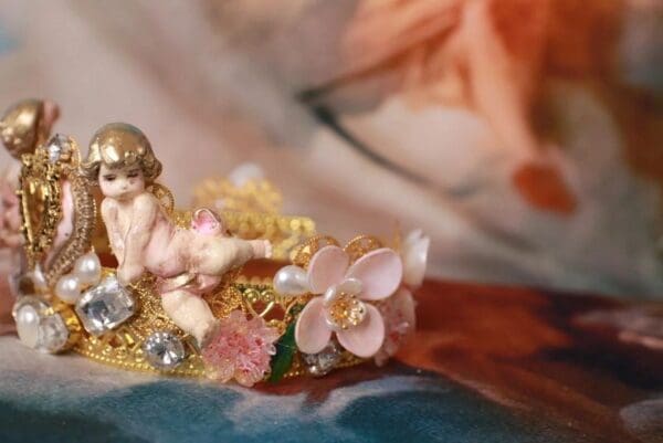 A small statue of an angel with flowers on it.