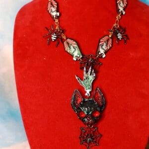 A red velvet display with a necklace and earrings.