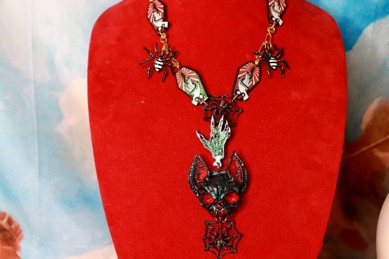 A red velvet display with a necklace and earrings.