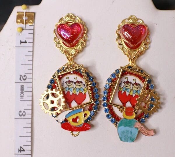 A pair of earrings with different designs on them