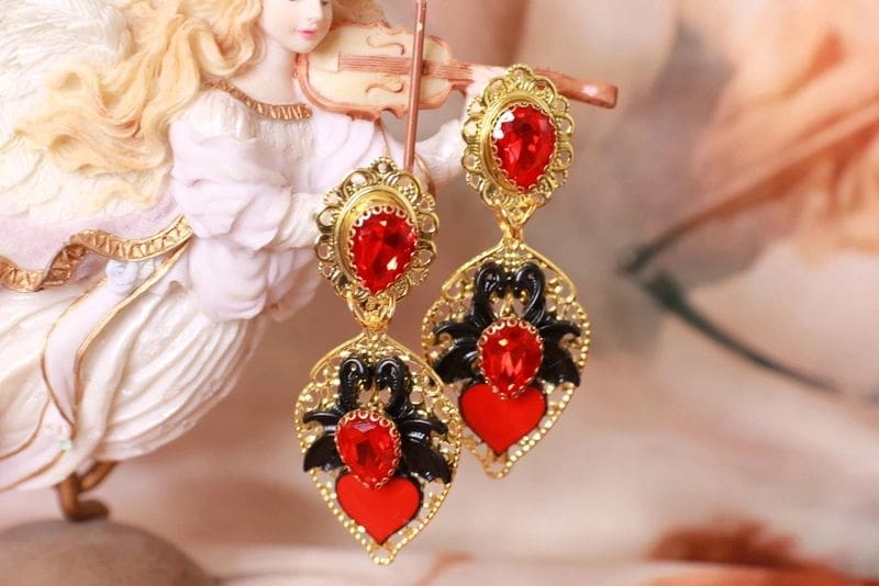 A pair of earrings hanging from the side of a statue.