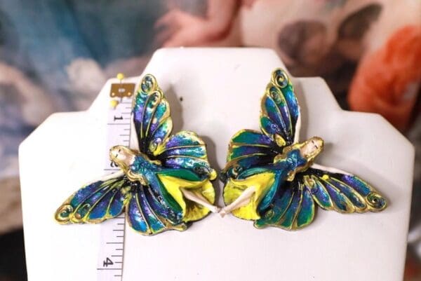 A pair of blue and yellow butterfly earrings.