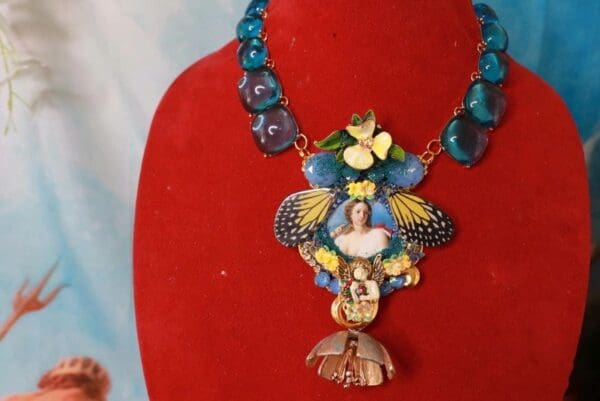 A necklace with a woman 's face on it.