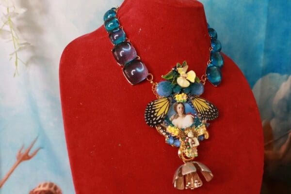 A red velvet display with a necklace on it