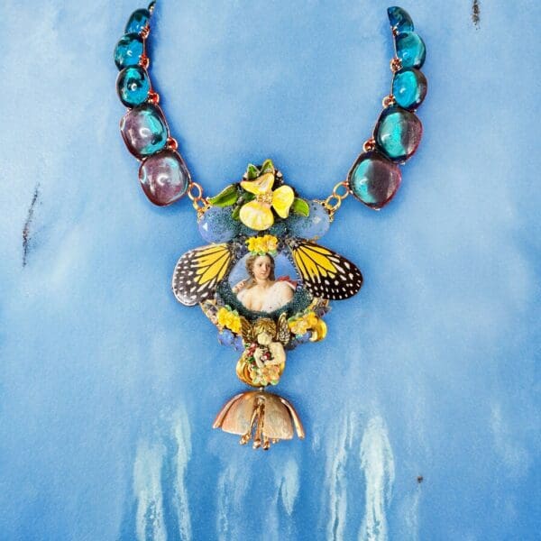 A necklace with various colored stones and a butterfly.