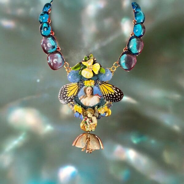 A necklace with a butterfly and flowers on it.