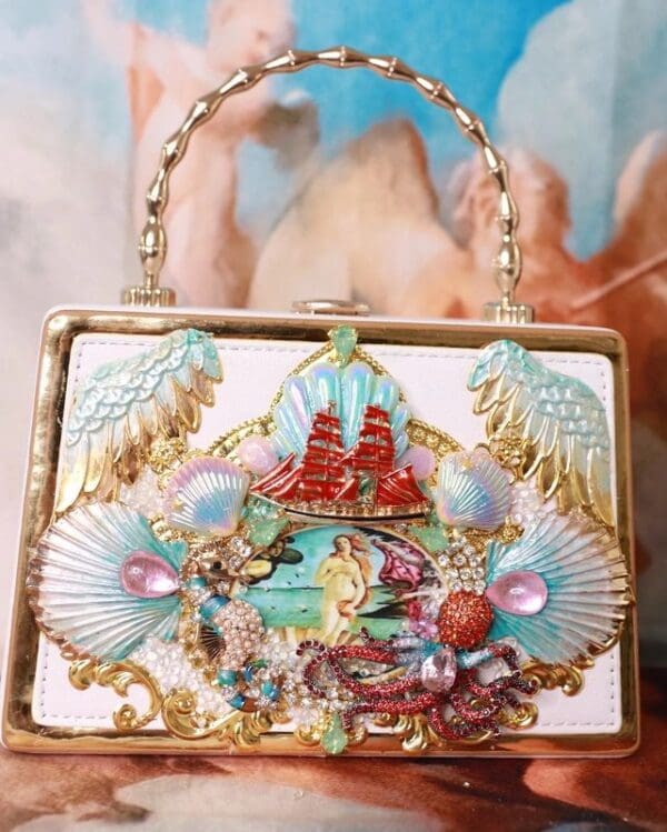 A purse with shells and sea animals on it.
