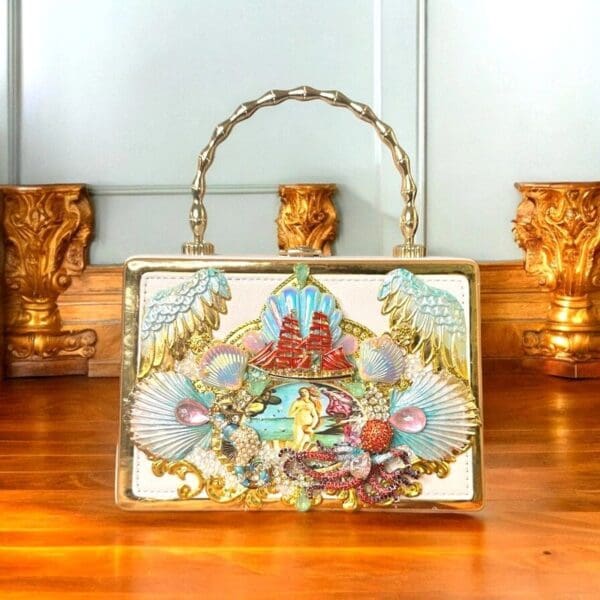 A white purse sitting on top of a wooden table.