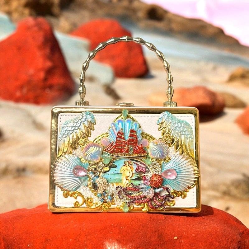 A purse sitting on top of a rock.