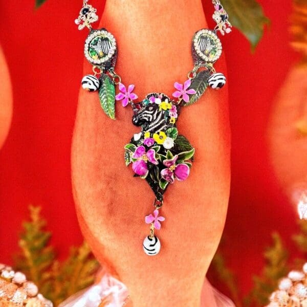 A close up of the necklace on someones hand