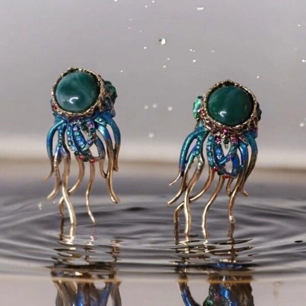 Two earrings are sitting in the water.