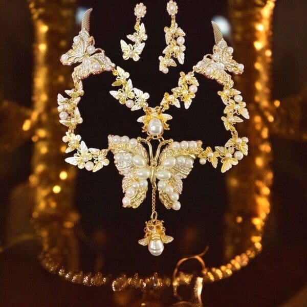 A gold necklace with a butterfly design on it.